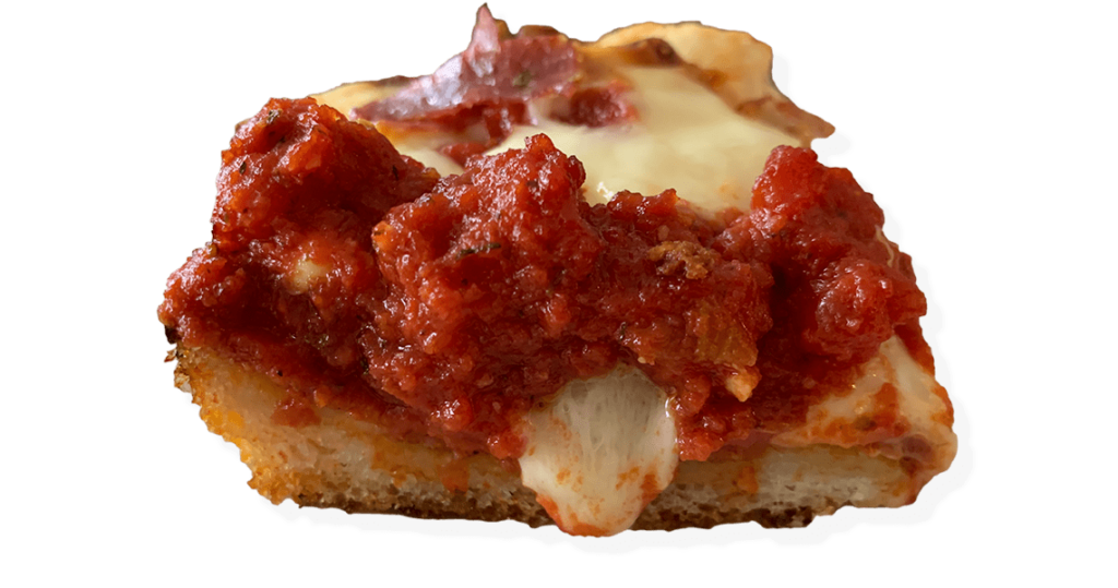 Slice of Detroit pizza with cheese oozing from side.